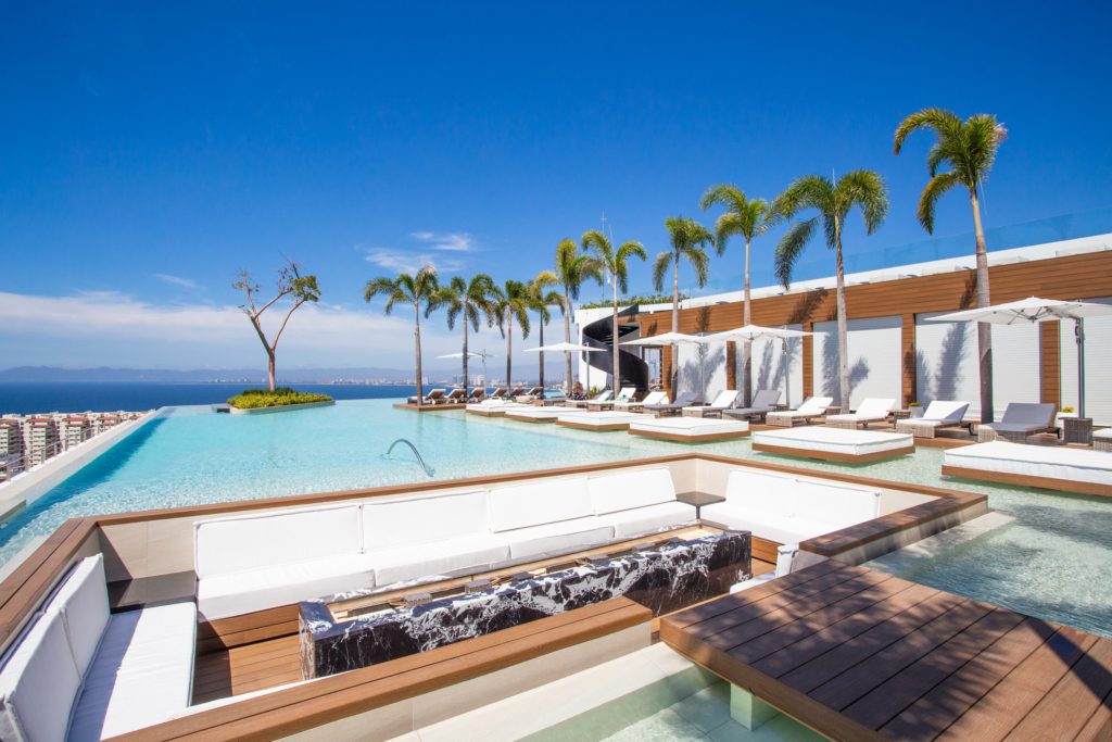 Rooftop pool with loungers and cabanas