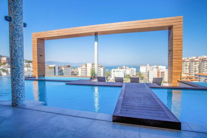 The Desire rooftop pool and its wooden frame, looking out to the bay