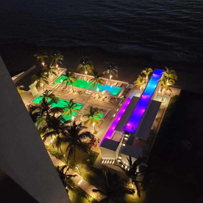 The Harbor 171 pools lit up at night, seen from above