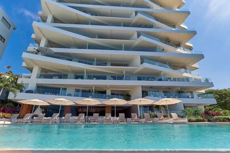 The third-floor pool and terrace at Indah, below the curved balconies of the building