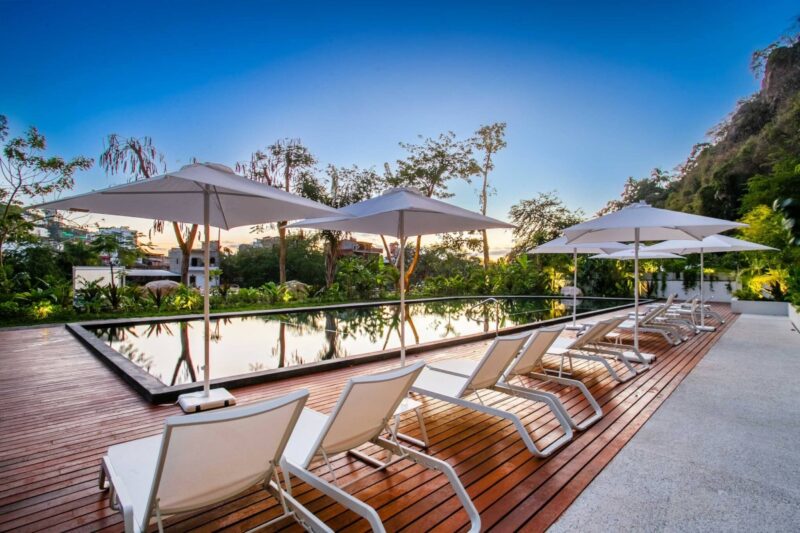 The riverside pool and loungers at Oasis at Rivera Cuale
