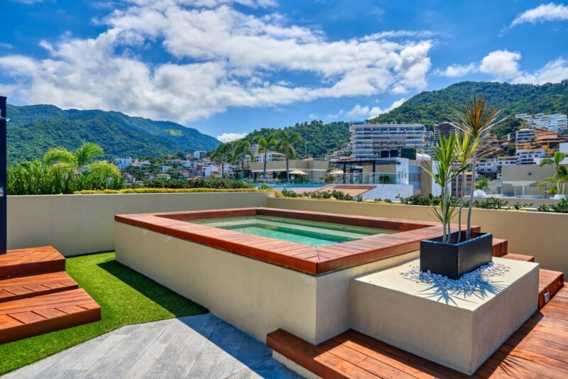 A rooftop jacuzzi at Pavilion, with the green hills behind