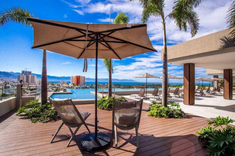 The Roma Encore rooftop deck, with the pool and the bay in the distance