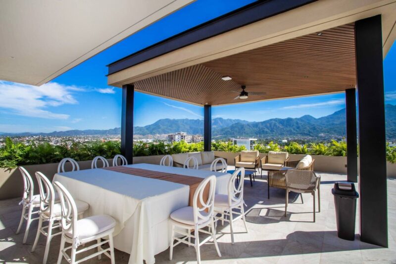 The dining table under the Roma Encore rooftop pergola