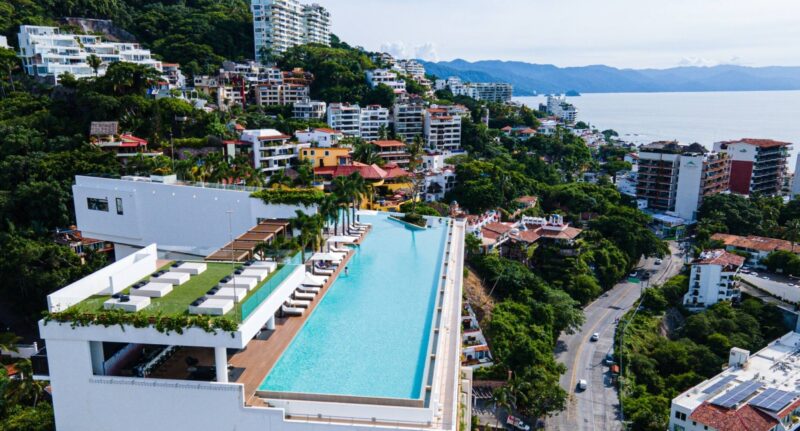 The Soho PV rooftop pool above the Romantic Zone, with Banderas Bay beyond