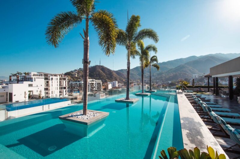 The Zenith rooftop infinity pool, with palm islands and the mountains behind